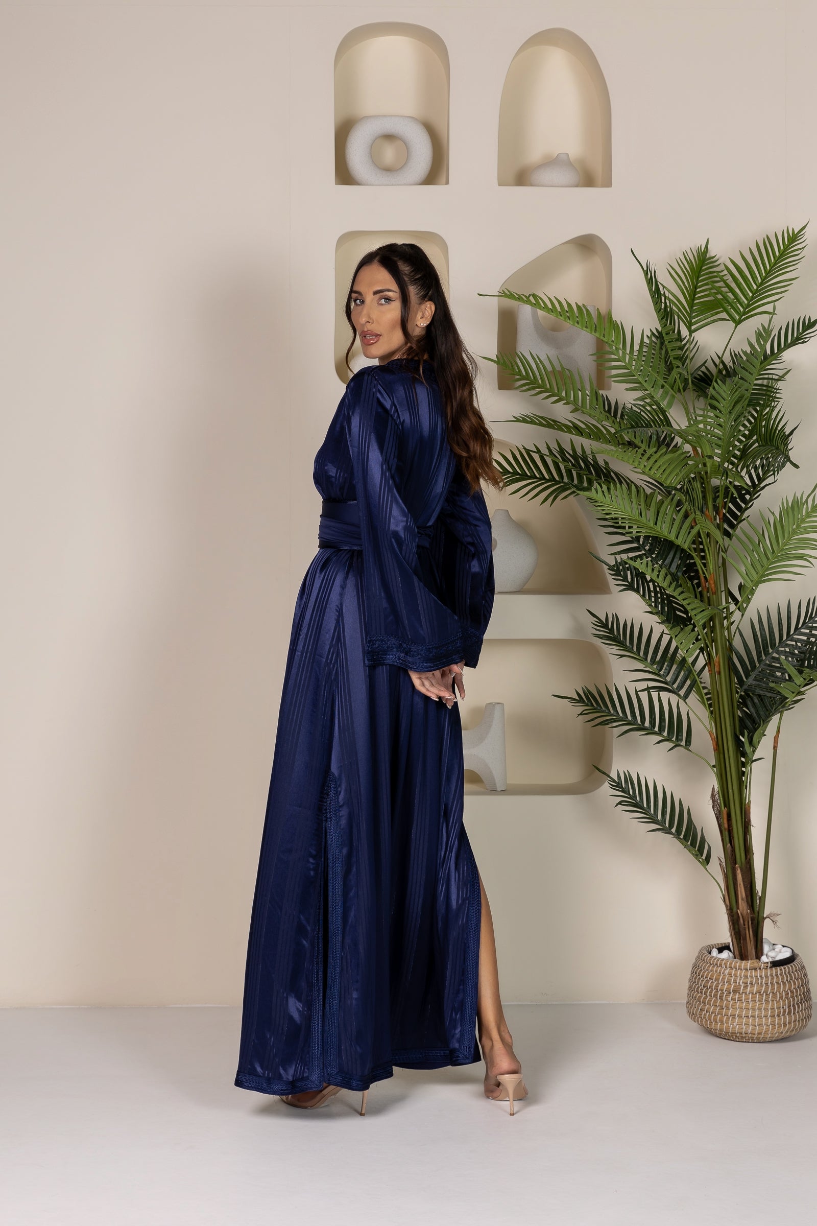 Back view of woman in dark blue Moroccan kaftan