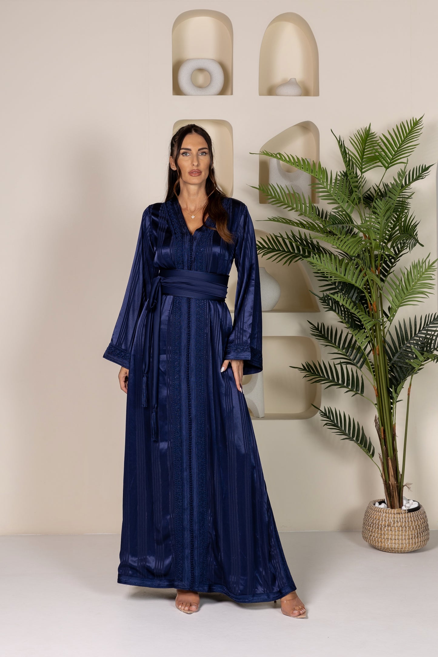 Woman in dark blue Moroccan kaftan with intricate embroidery