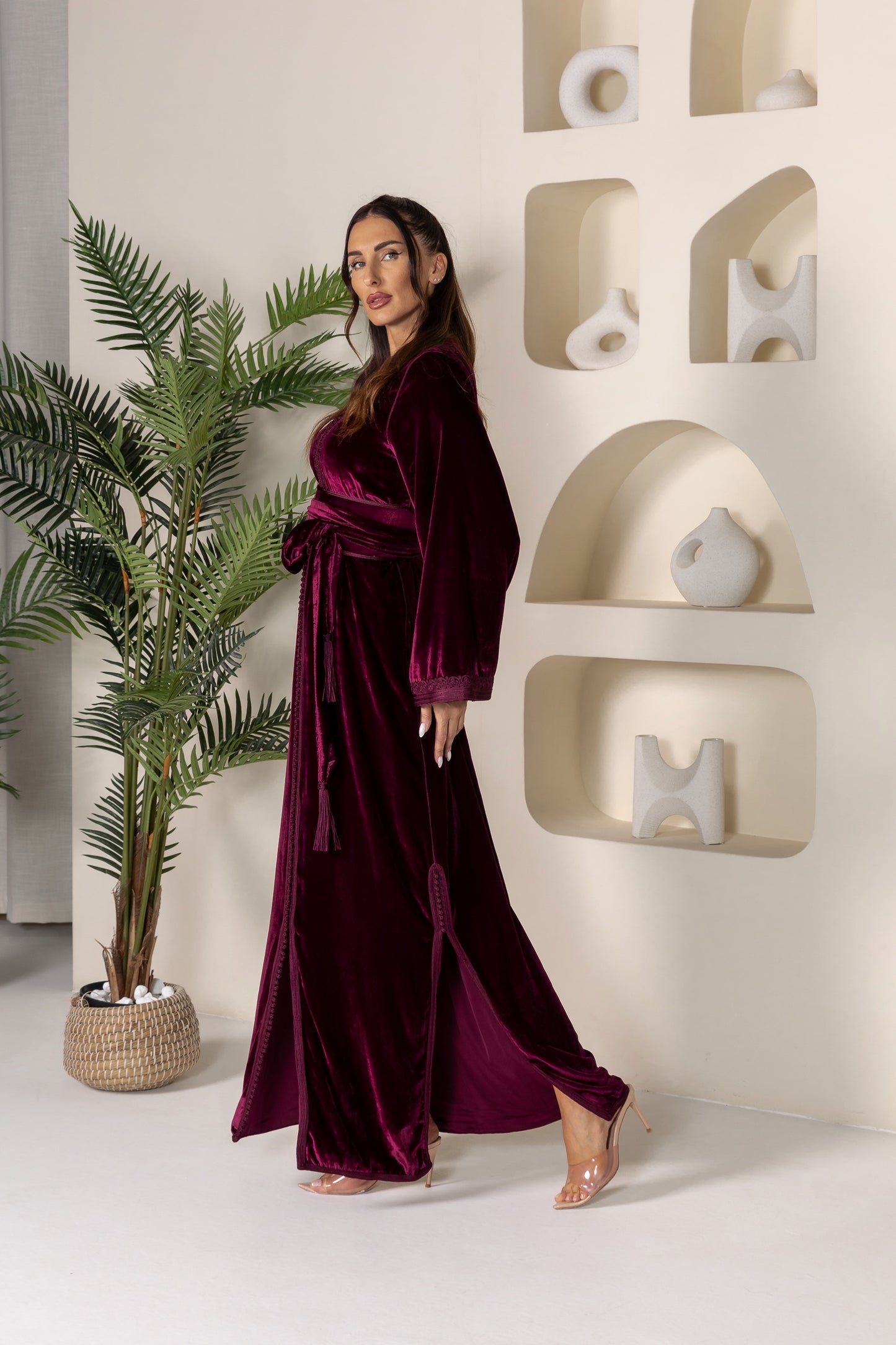 Side view of maroon velvet Moroccan kaftan showing elegant design and belt