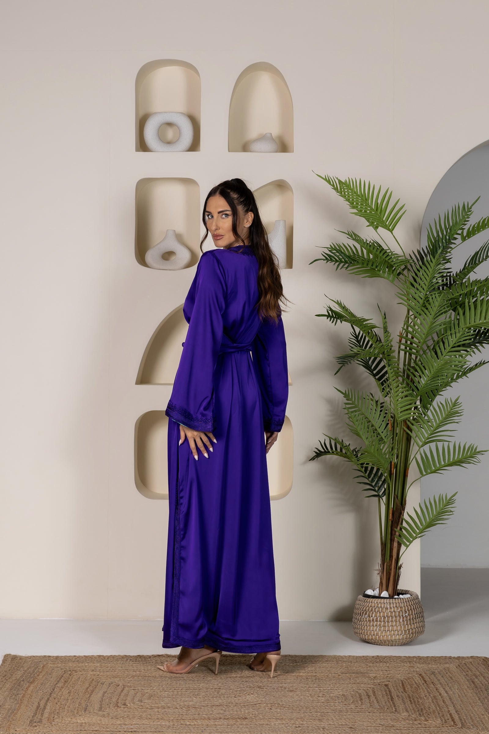 Back view of purple Moroccan kaftan with teal accents on wide sleeves