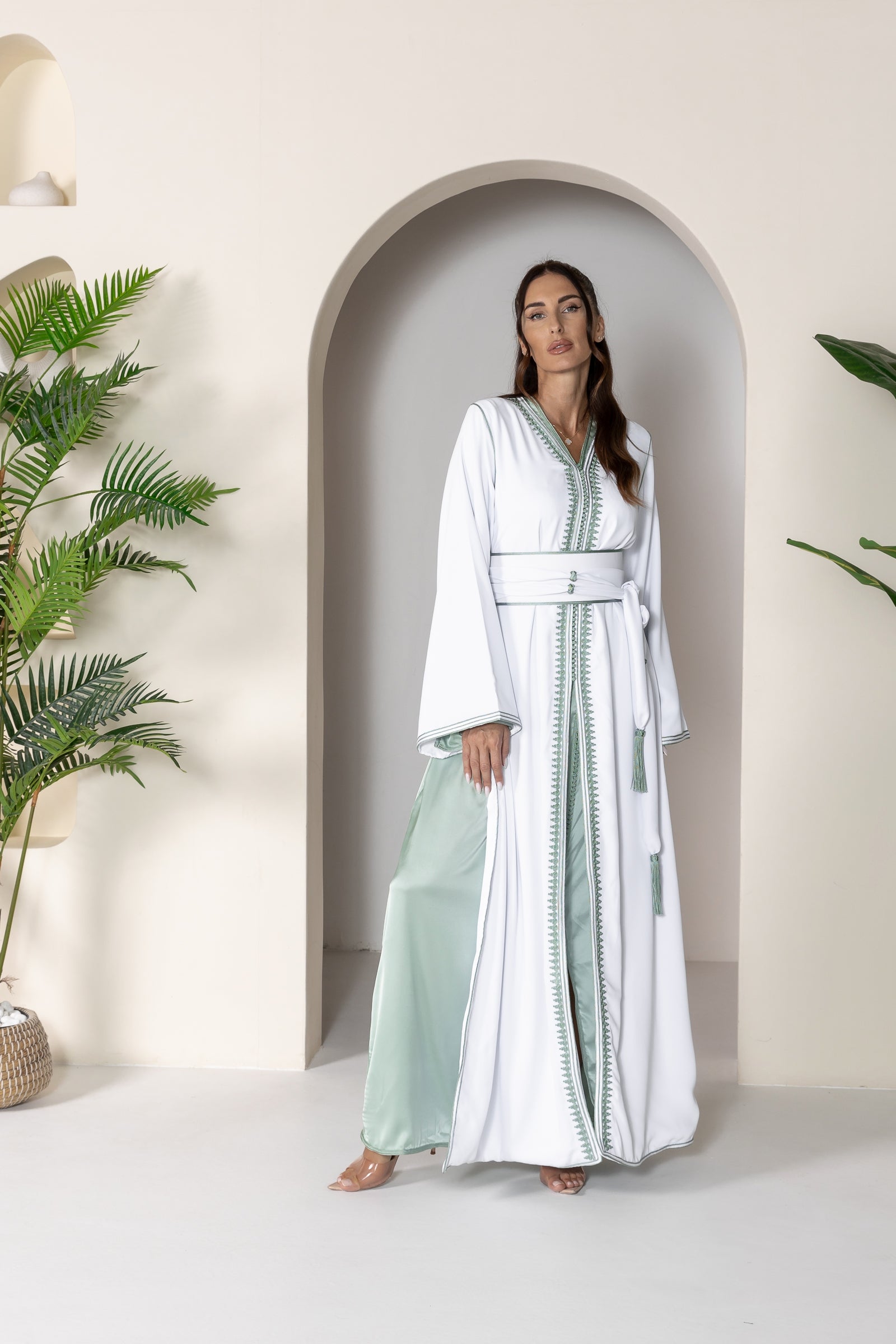 Full front view of white Moroccan kaftan with green accents and belt