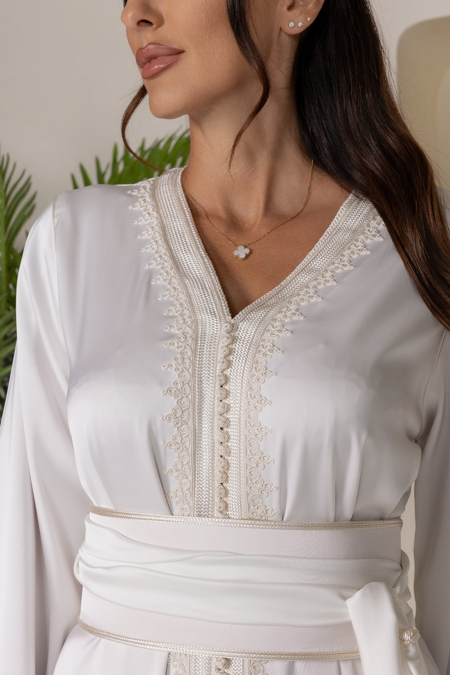 Detailed view of intricate embroidery on white Moroccan kaftan sleeves