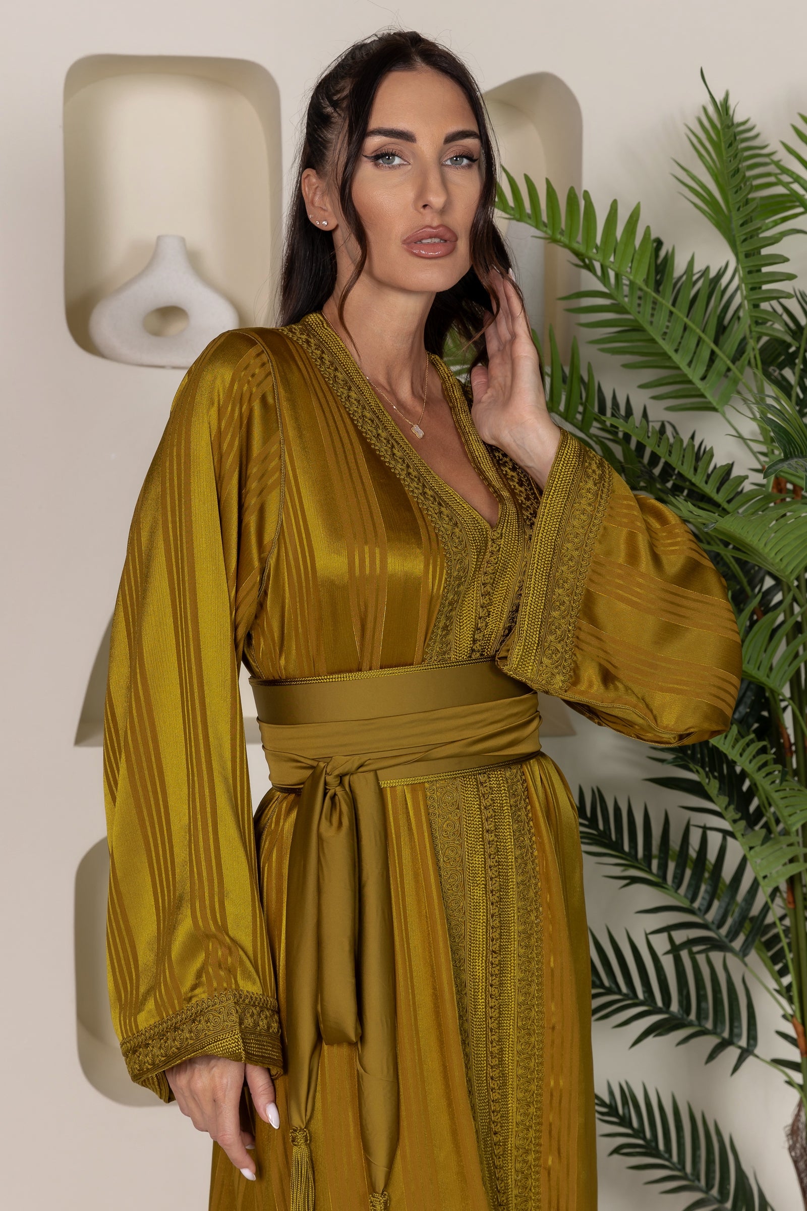 Full front view of a mustard yellow Moroccan kaftan with a tied sash and wide sleeves