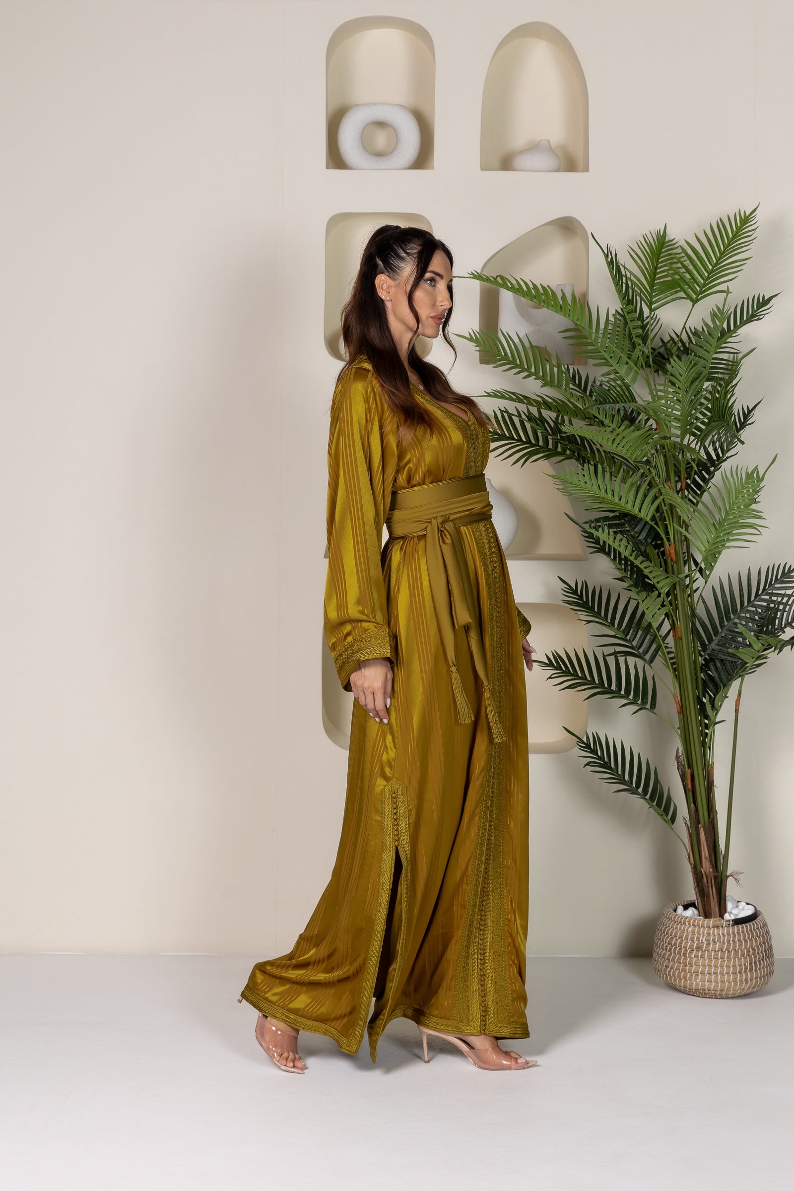 Side view of a mustard yellow Moroccan kaftan highlighting its flowing cut and fabric